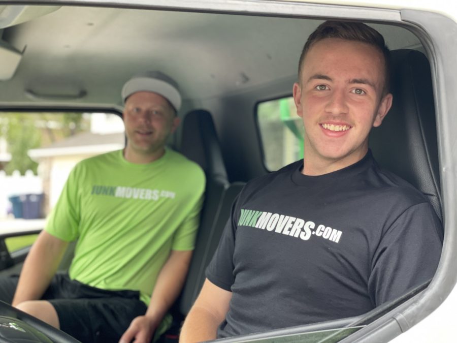 Two Junk Movers professionals on their way to perform junk removal services